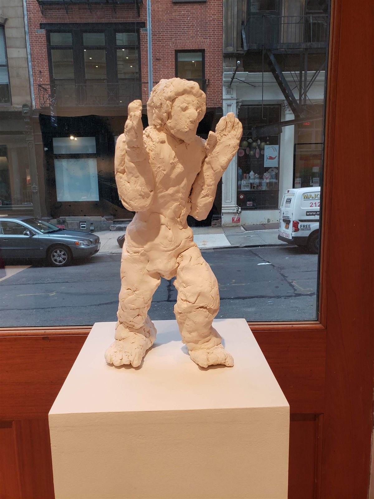 Cara de Pancake seen from the front, on a plinth in a gallery window